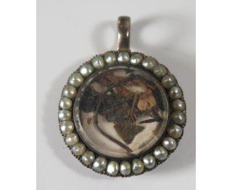 An Antique Pearl Mounted Memorial Locket with hinged panel, 26mm diam. 