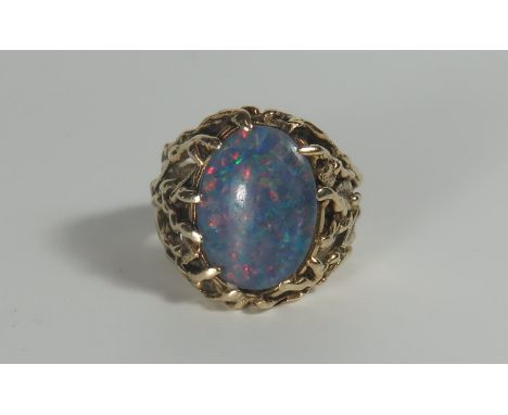 An Unmarked Gold and Black Opal Ring in a naturalistic foliate setting, c. 17.5x13mm stone, size Q.5, 15.5g. Resized 