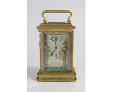 A Miniature Brass Carriage Clock with porcelain mounts, 9cm. Running with key 