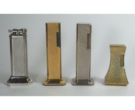 Four Dunhill Table Lighters. All striking, shaped silver plated also lighting 