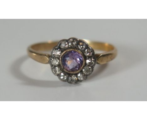 An Antique Amethyst and Diamond Cluster Ring in an unmarked gold setting, 10mm head, size Q, 2.3g 