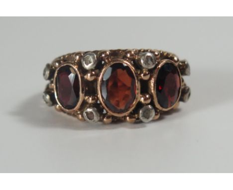 A Garnet and Rose Cut Diamond Ring in a rub over unmarked gold setting, 23x11mm head, size K, 7.1g 