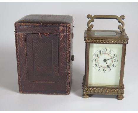 A Cased 19th Century Gilt Brass Carriage Clock with floral decorated enamel dial, 15cm high, running 