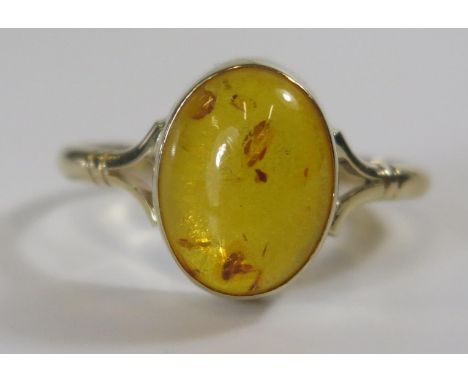 A 9ct Gold and Amber Ring, 14x11mm head, size V.5, 2.8g 