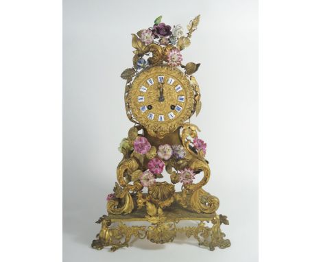 A French 19th Century Gilt Metal Mantle Clock with applied ceramic flower decoration, striking movement by Stevenard of Boulo