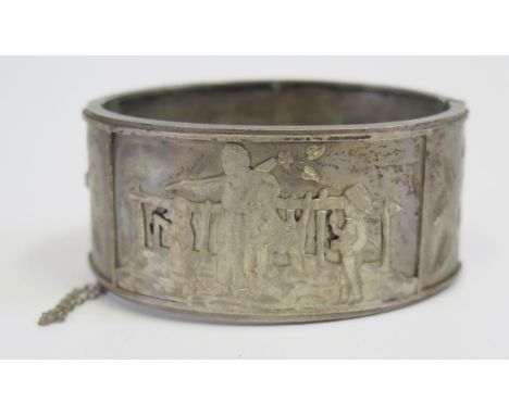 An Unmarked 19th century Silver Hinged Bangle with relief decoration of a woman with children working, 36g 