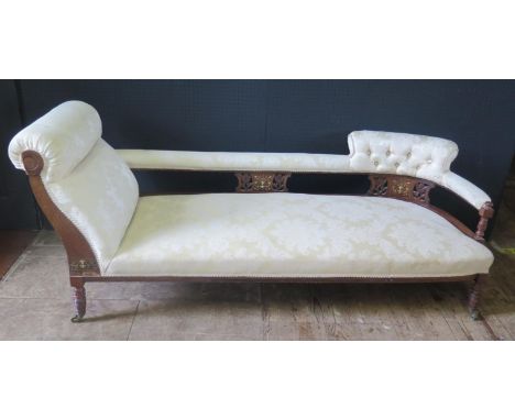 An Edwardian Chaise Longue, carved and inlaid back panel, turned legs with castors. L. 182cm, H. 75cm, D. 87cm. 