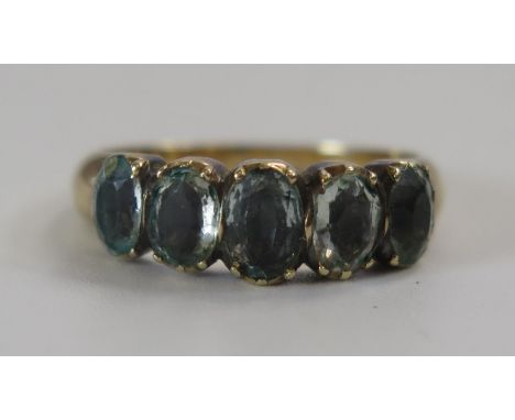 A Georgian Foil Backed Blue Paste Five Stone Ring in an unmarked gold setting, size J.5, 2.5g 