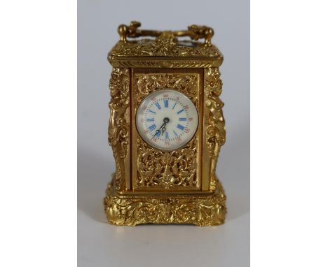 An Ornate Gilt Cased Miniature Carriage Clock decorated with caryatids, 8.5cm. Running with key 