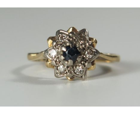 An 18ct Gold, Sapphire and Diamond Cluster Ring, 11mm head, size K.5, 3g 