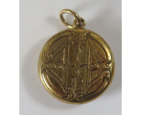 An Unmarked Victorian 15ct Gold Memorial Locket with hair glazed panel verso and chased foliate decoration, 17mm diam., 2.5g 