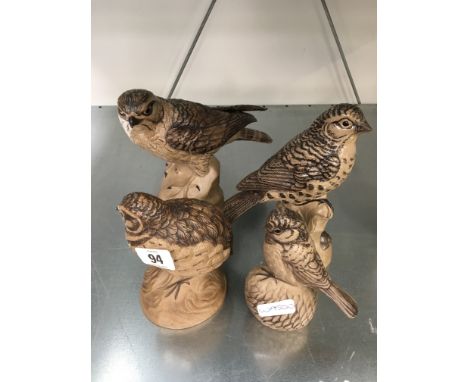 A Poole Pottery Barbara Linley Adams stoneware model of a Merlin together with three other stoneware birds.