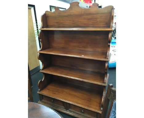 A French mahogany four tier buffet with scroll carved back fitted two drawers, brass knobs below, resting on bracket feet, 4'