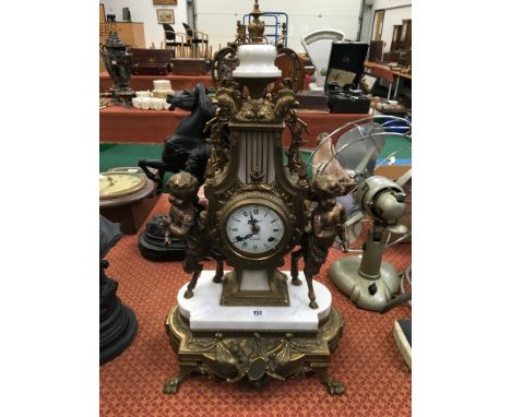 An Empire style brass and marble cased mantle clock by Regnant, Paris, decorated with Young Minotaurs on marble and brass bas