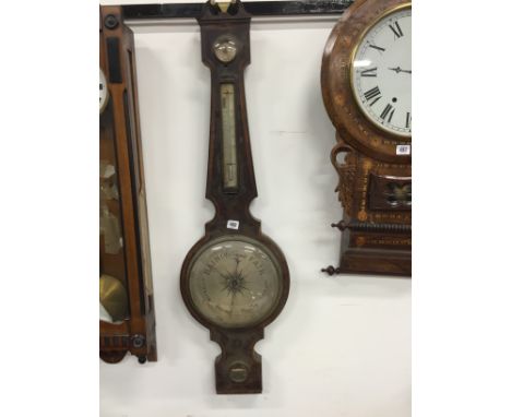 An early 19th century inlaid mahogany cased wheel barometer with swan neck pediment by Hockey & Son, Stalbridge with original