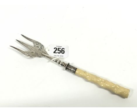 A Victorian pickle fork with turned bone handle.