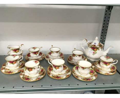 The residue of a Royal Albert bone china tea service decorated in the Old Country Roses pattern complete for eight with teapo