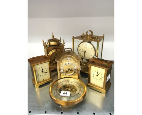 Five various brass and gilt metal cased mantle clocks together with a barometer.