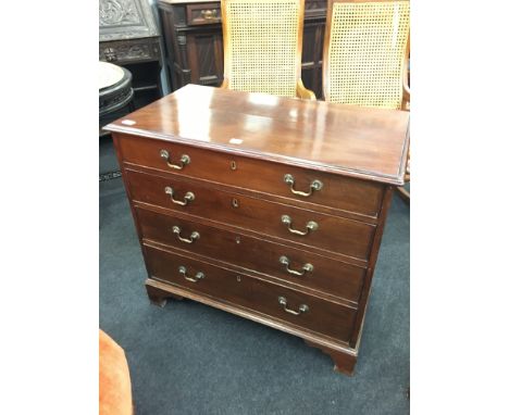 A Georgian design straight front chest of four graduated drawers, resting on bracket feet.
