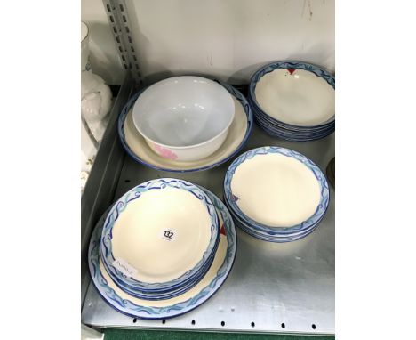 The residue of a Poole Pottery breakfast service decorated in the Boats pattern (chip to one plate) together with a large mat