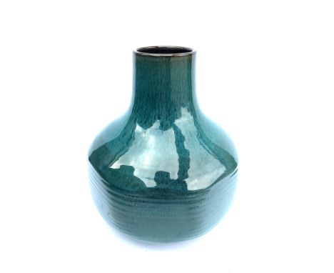 A Poole Pottery Atlantis vase by Guy Sydenham in a black clay body of ribbed and faceted form, glazed in a blue grey reactive