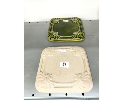 A Poole Pottery Carter & Co. green glazed teapot stand together with another.