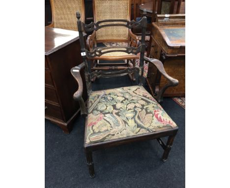 An early Chippendale style mahogany elbow chair with pierced lattice back, acorn knobs, fluted legs, trellis work cross stret