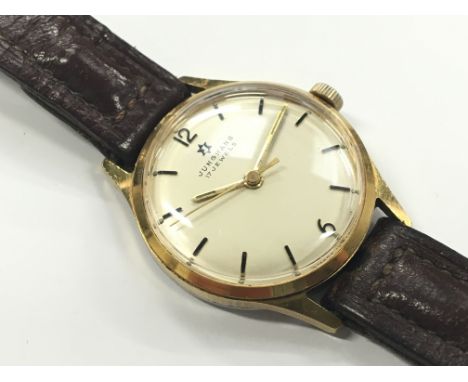 A stainless steel cased gold plated mid size Junghans 17 jewels manual wind wrist watch, champagne dial with black baton nume