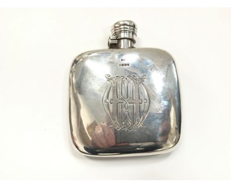 An early 20th century silver hip flask with engraved initial decoration (116 grams overall).