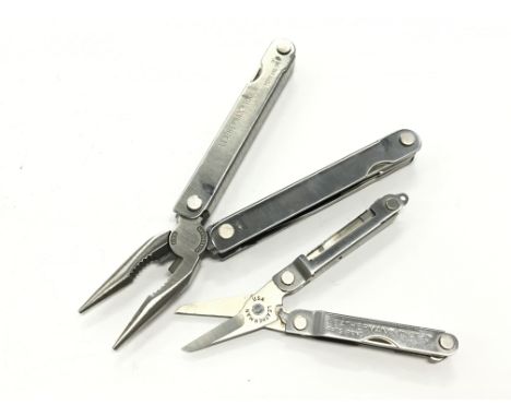 Two Leatherman fold up pocket tools, scissors, pen knife, tweezers, sharpeners, ruler.