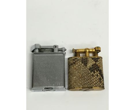 A Dunhill Unique cigarette lighter with snakeskin case together with a chrome plated roller Beacon cigarette lighter.
