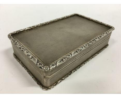 An engine turned silver snuff box with gilt interior.