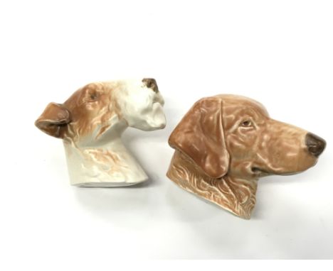A Poole Pottery wall plaque modelled as a Sealyham Terrier together with a similar of a Labrador, designed by Harry Brown.
