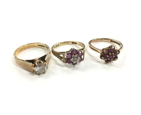 A 9 carat gold ruby and diamond ring together with a 9 carat gold ruby ring and a 9 carat gold white stone ring (total weight