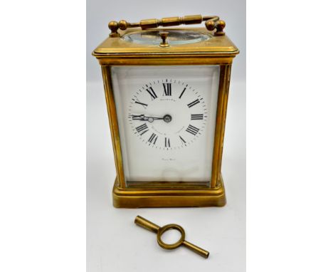 A gilt brass cased carriage timepiece Plain corniche case, enamel dial with Roman numerals, French movement, with push repeat