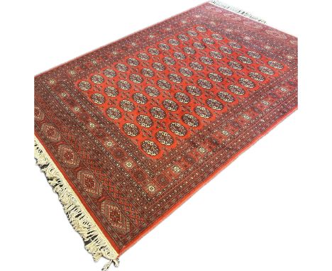 A large Bokhara rug, Madder field with five rows of boteh, multiple guard bands [238 x 170cm]