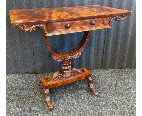 Regency mahogany side tableThe rounded rectangular crossbanded top above frieze drawer, curved support with leaf clasping ont