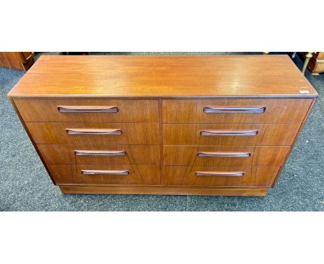 A Mid-Century G-Plan double chest of drawers sideboard, the rectangular surface above eight drawers with sculptural handles.