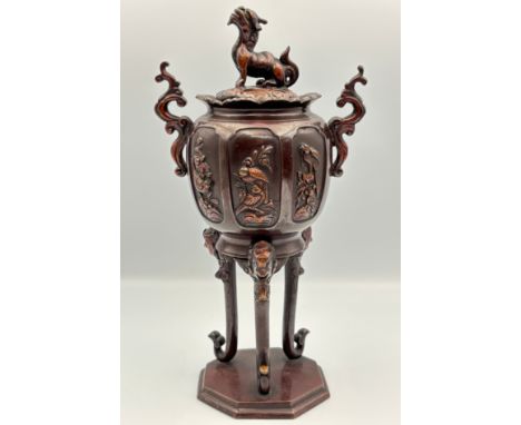 A Japanese small bronze Koro and coverDog of Fold over finial to the cover, scroll handles and cast reserve panels with lands