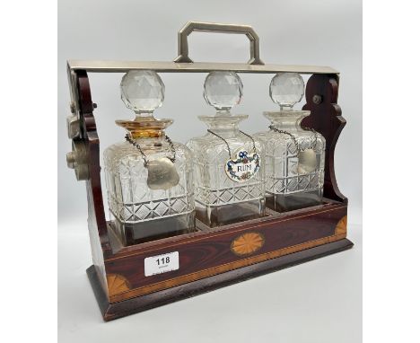 19th century mahogany inlaid tantalus together with three cut glass decanters with labels. 
