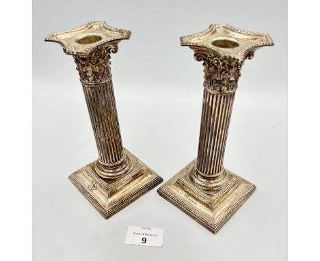 Pair of silver candlesticks, Corinthian column design, stepped square base. Henry Matthews Birmingham 1927