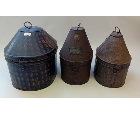 A group of three various japanned tin helmet cases 