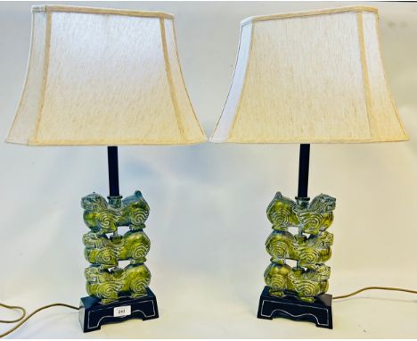 Pair of Chinese bronze effect table lamps with stacked dogs fold over to the base