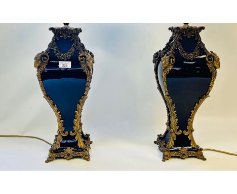 Of French bleu de Roi porcelain and gilt metal mounted table lamps The square baluster ceramic bodies with bold metal mounts,