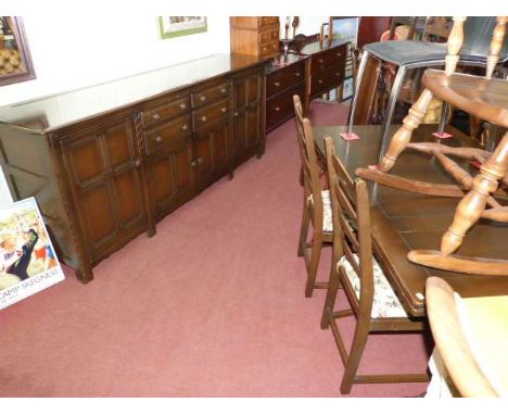 Ercol four door sideboard, draw leaf dining table and four ladder back chairs