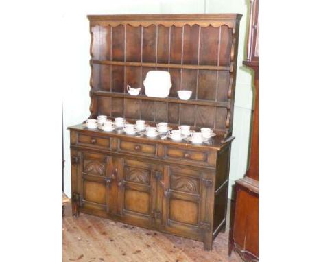Good quality oak dresser having shelf back above three long drawers with three carved panel doors below