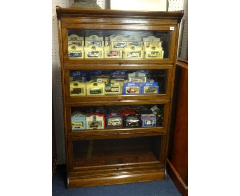 An oak four section bookcase, of Globe Wernicke style, height 140cm.