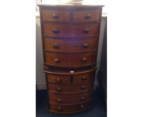 A pair of miniature mahogany bow fronted chest of drawers, width 47.5cm (2).