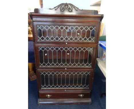 A mahogany three section Globe Wernicke style bookcase with leaded glazed doors and lower fitted drawer.