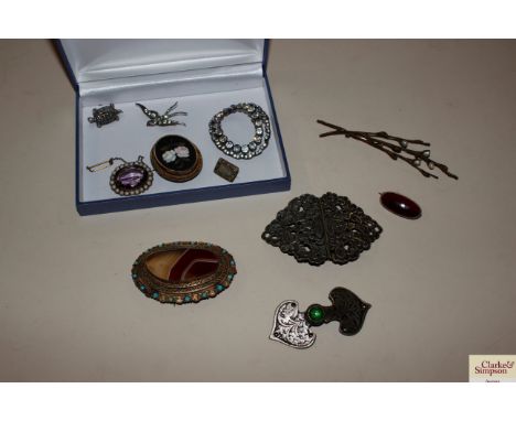 An oval Pietra Dura memorial brooch, an amethyst coloured yellow metal and seed pearl decorated broch, an agate and turquoise
